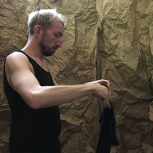 Performer is folding black clothes